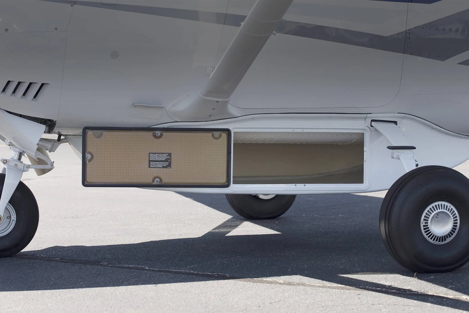A close-up of the underside of a Cessna Stationair, showing the cargo pod.
