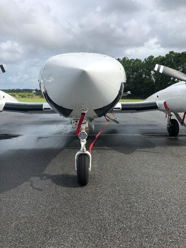 Close-up of the nose and front landing gear of the N513JN aircraft.