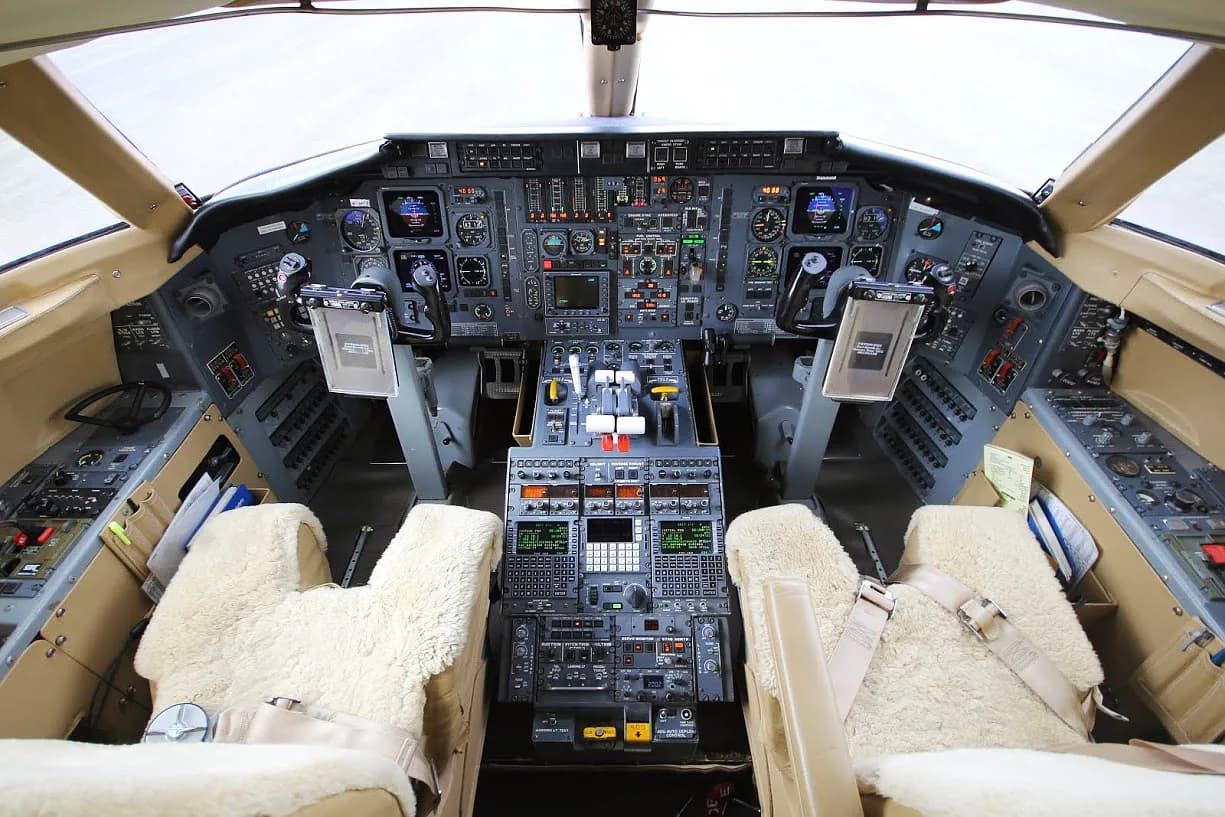 View of the Challenger aircraft cockpit instrument panel and seats.