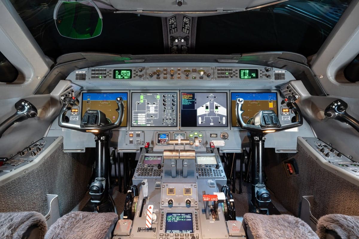 The cockpit of the aircraft features multiple display screens and control panels.