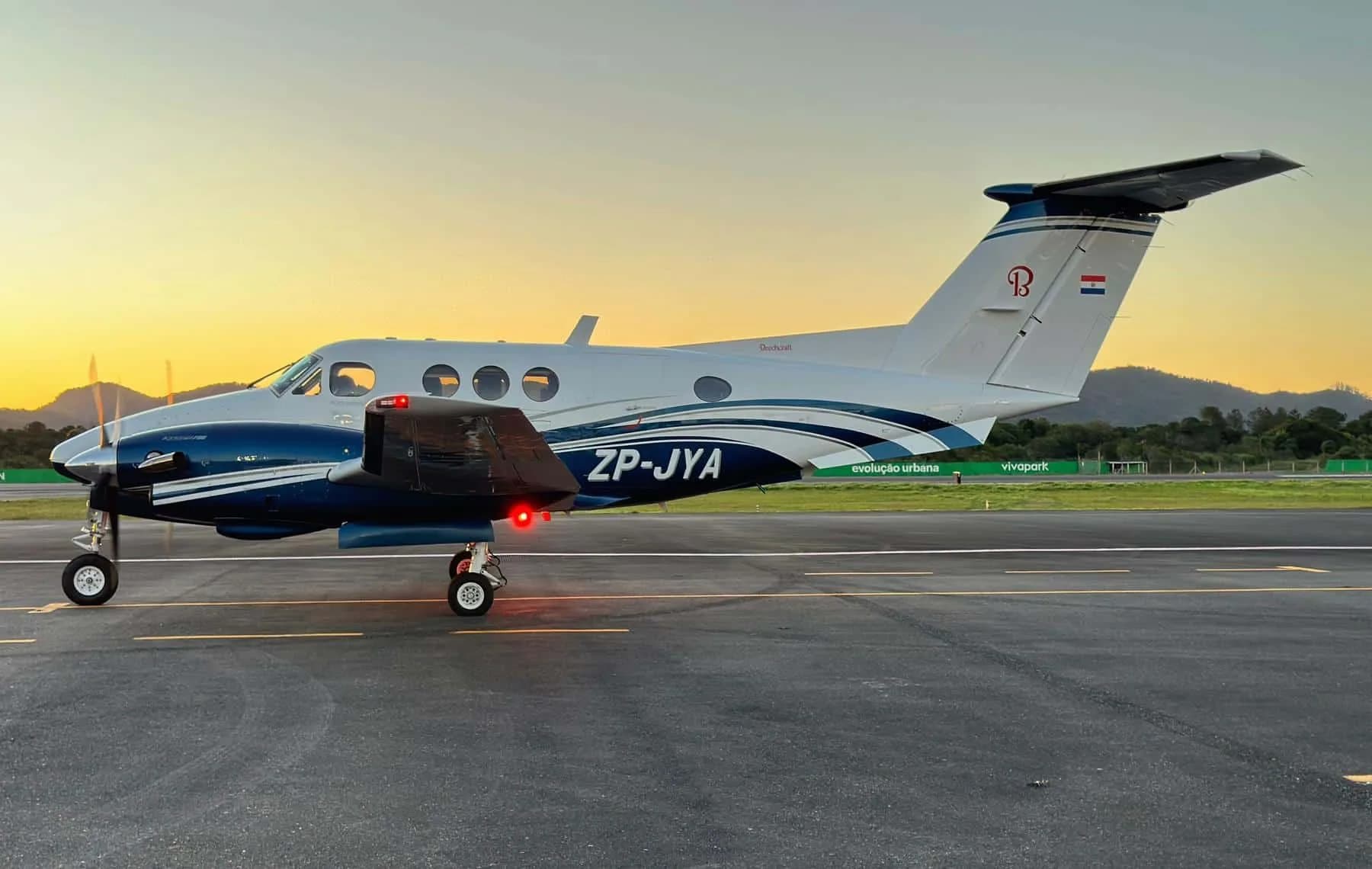 A Beechcraft King Air turboprop aircraft with a blue and white paint scheme.