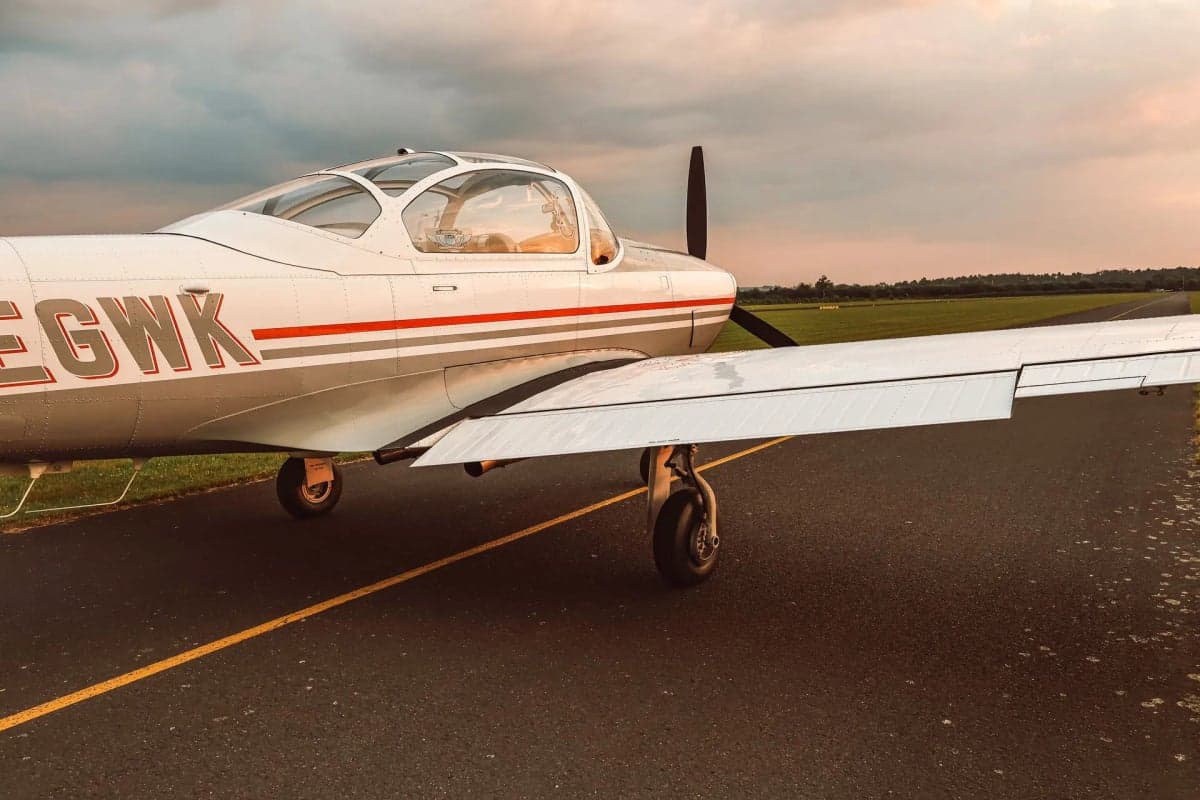 The D-EGWK aircraft is parked on the runway with a gray and white paint scheme.