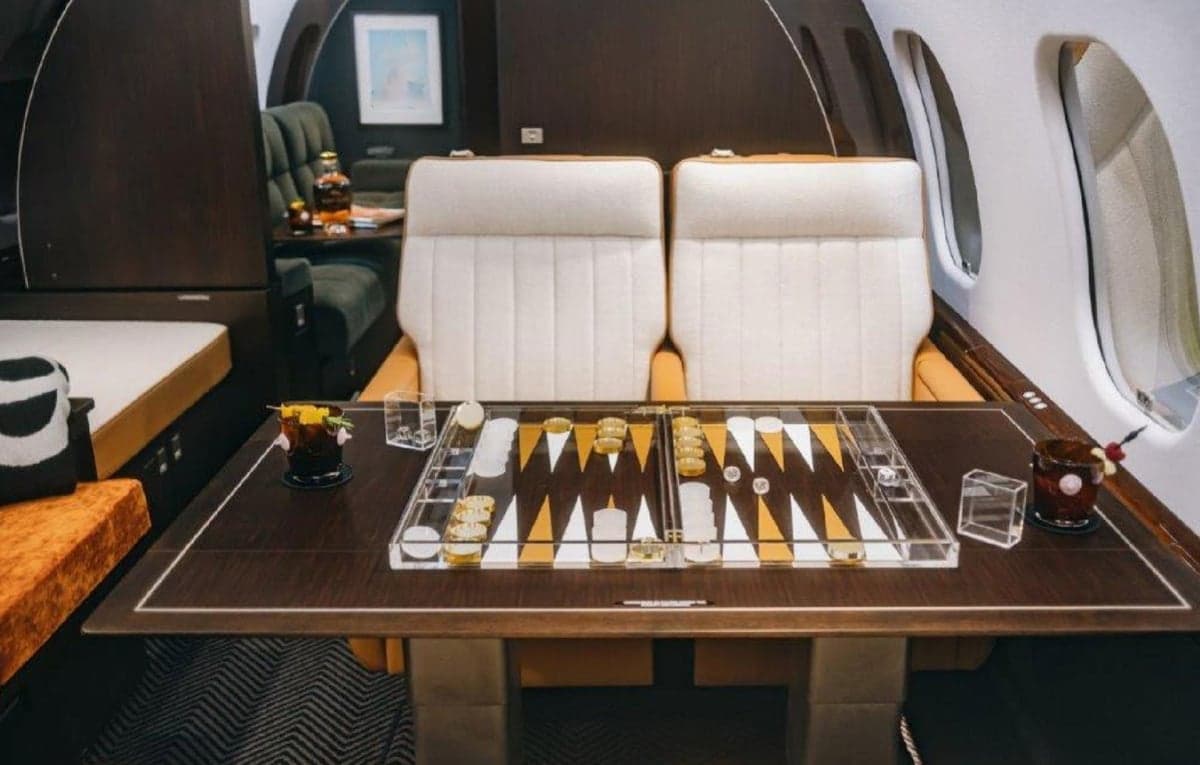 A view of the aircraft's interior with a backgammon table and seating.