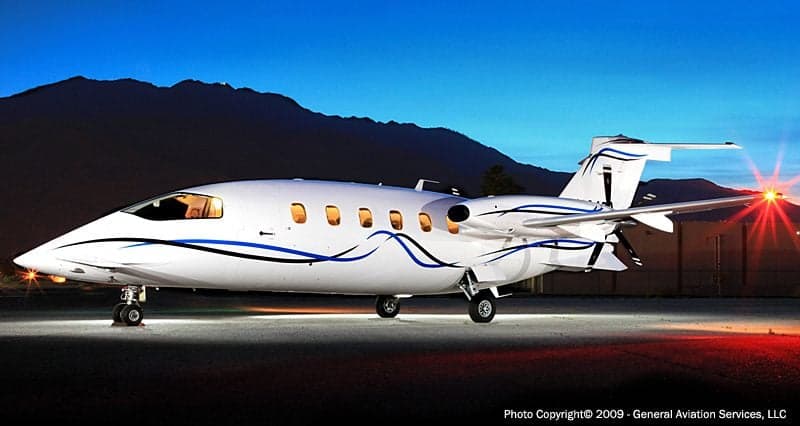 Stock photo of a Piaggio Avanti aircraft at dusk.
