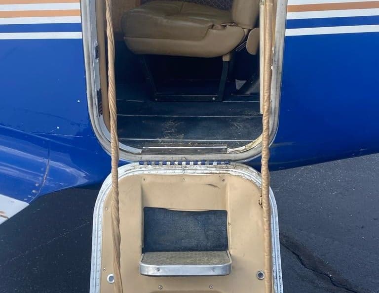 View of the aircraft's entry steps and a cabin seat.