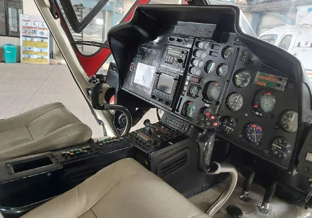 The detailed instrument panel and controls of the helicopter's cockpit.