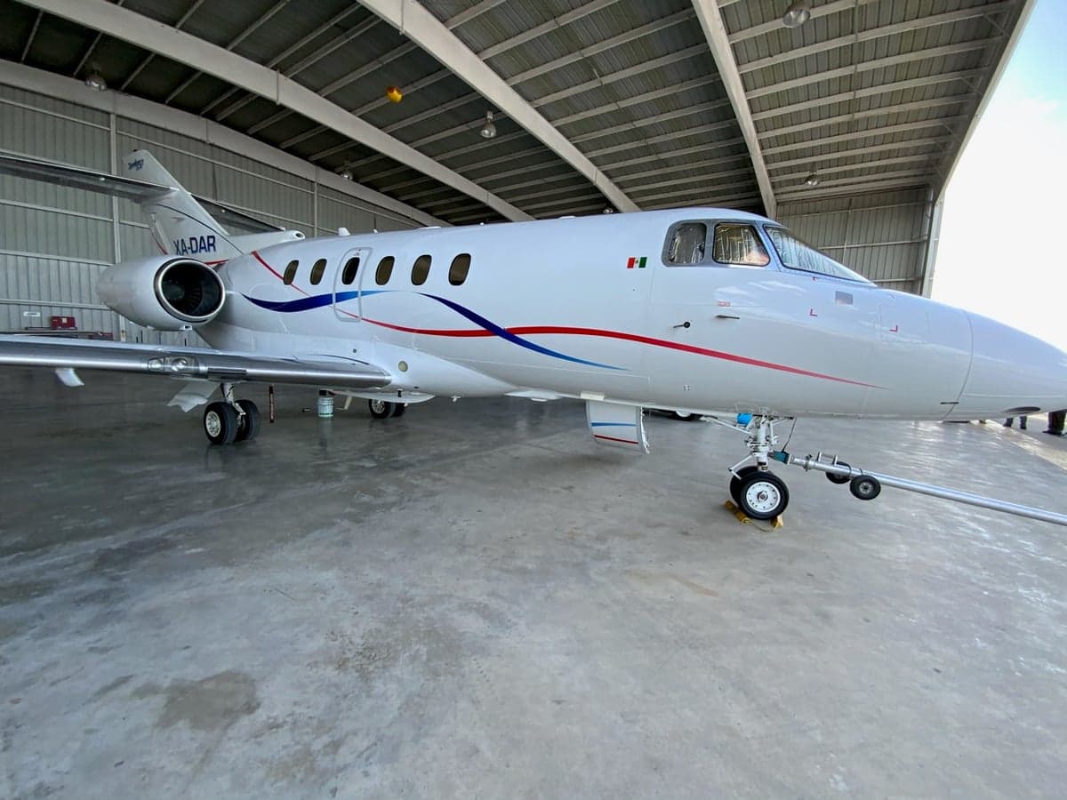 XA-DAR Falcon 50 parked in a hangar, side view.