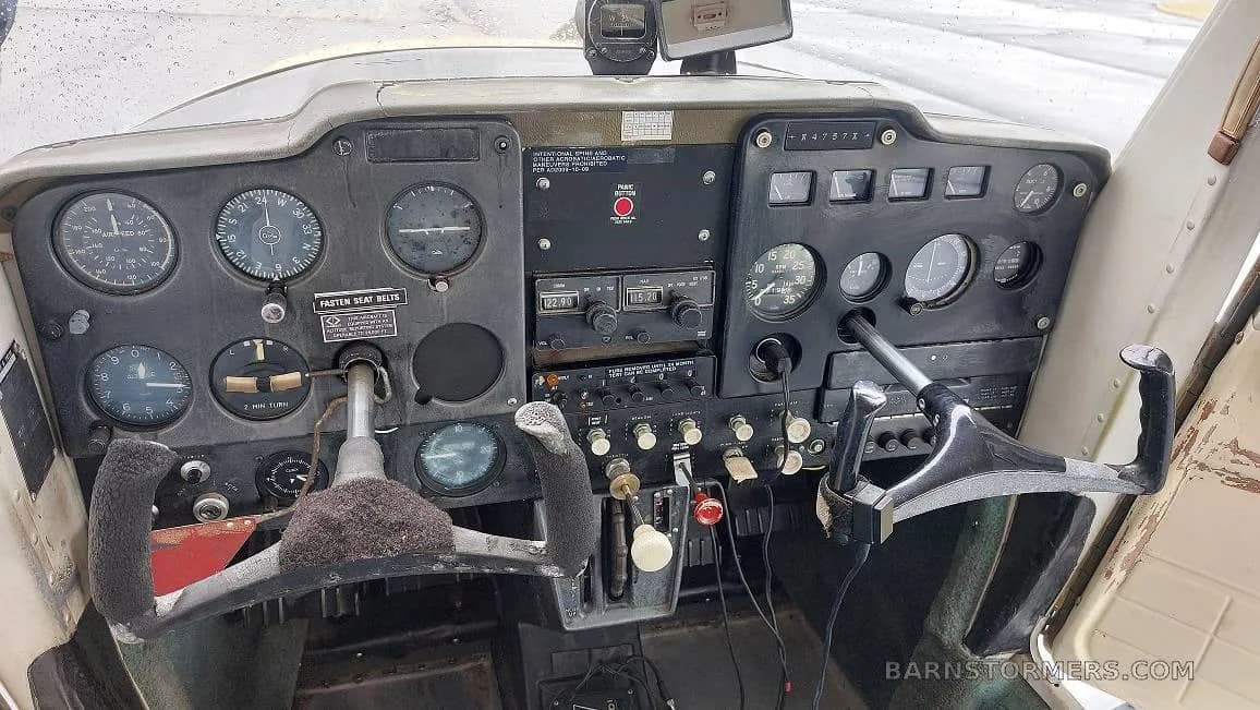 View of the instrument panel and yokes in the cockpit of a Cessna 150.
