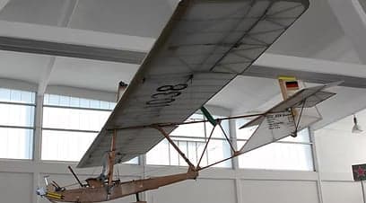A vintage aircraft on display indoors.