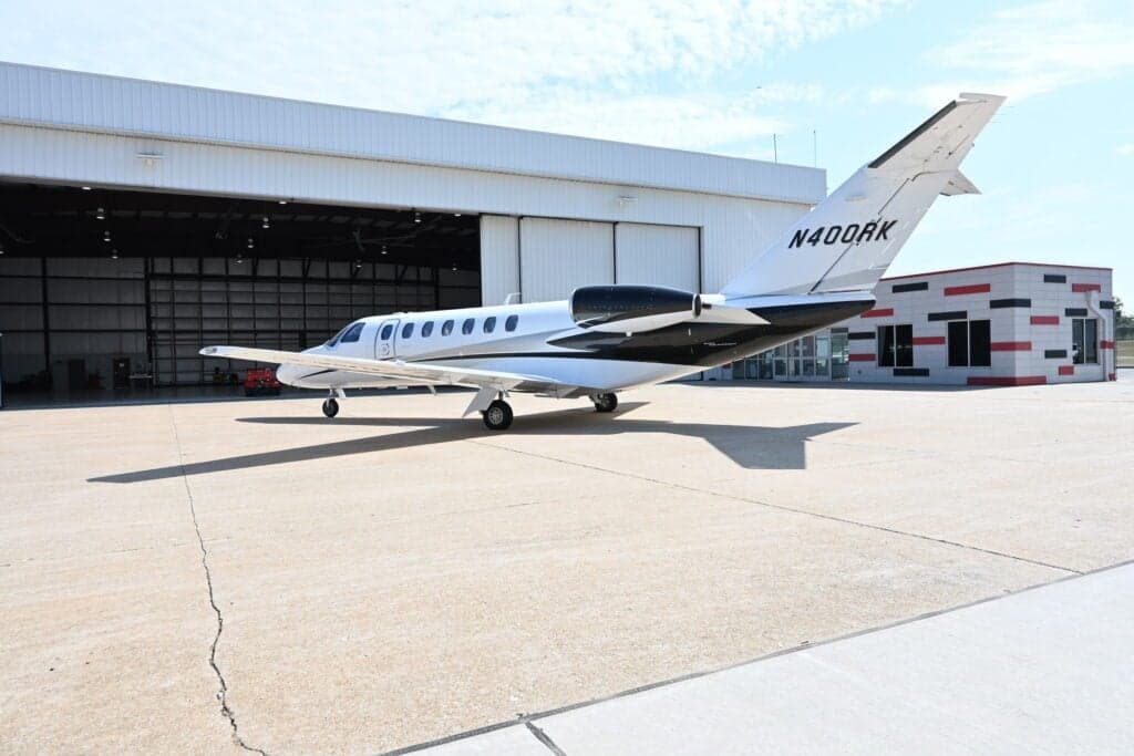 N400RK Cessna Citation CJ3+ parked in front of a hangar on a sunny day.