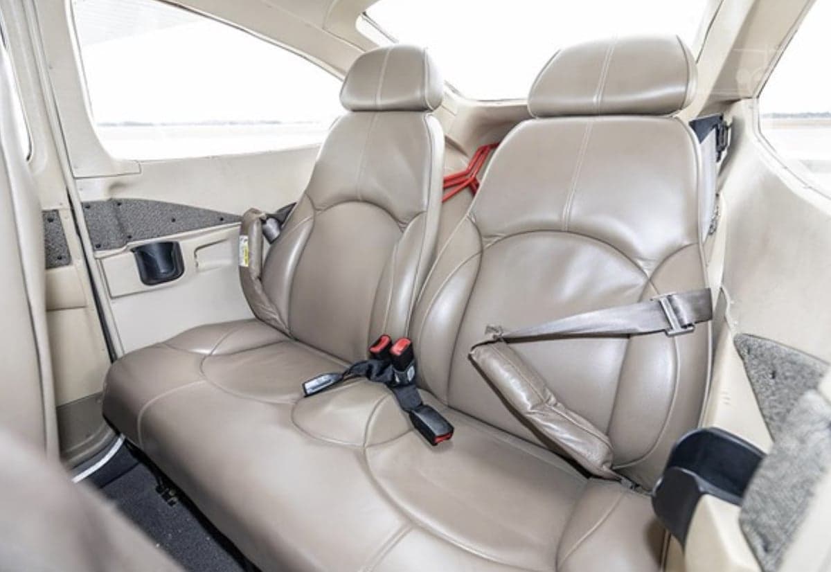 Beige leather seats in the cabin of the aircraft.