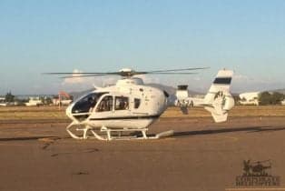 An EC135 helicopter parked on the tarmac.