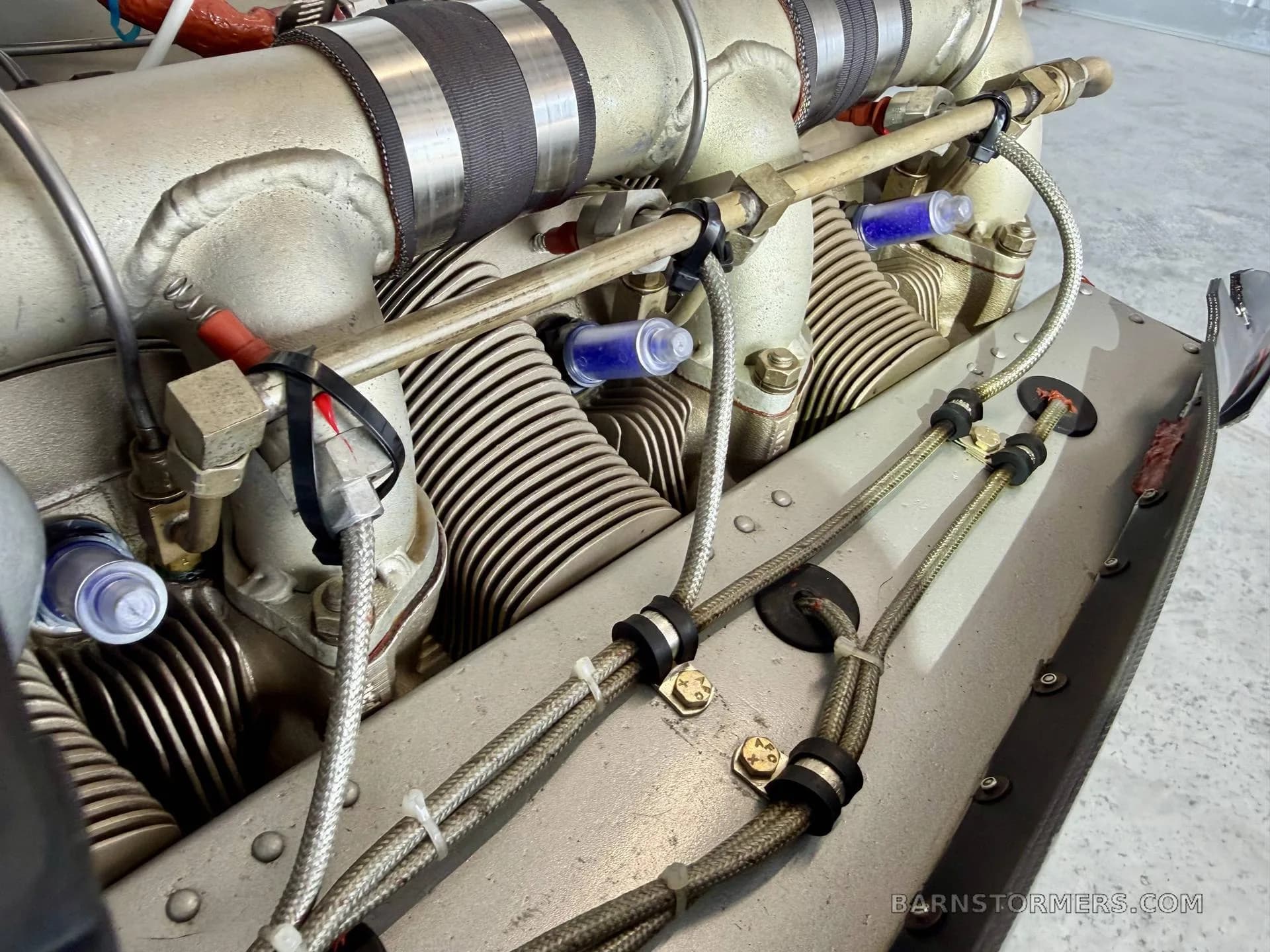 A close-up view of the cylinders and fuel lines of a Continental aircraft engine.