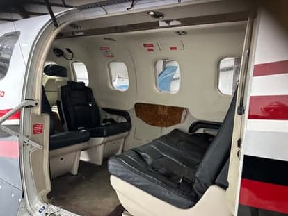 View of the cabin seats with the aircraft door open.