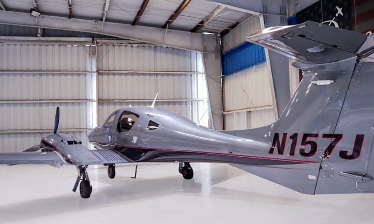 Diamond DA62 aircraft tail number N157J in a hangar.
