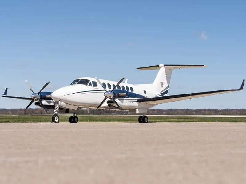 Beechcraft King Air 350i aircraft on the ground, side view.