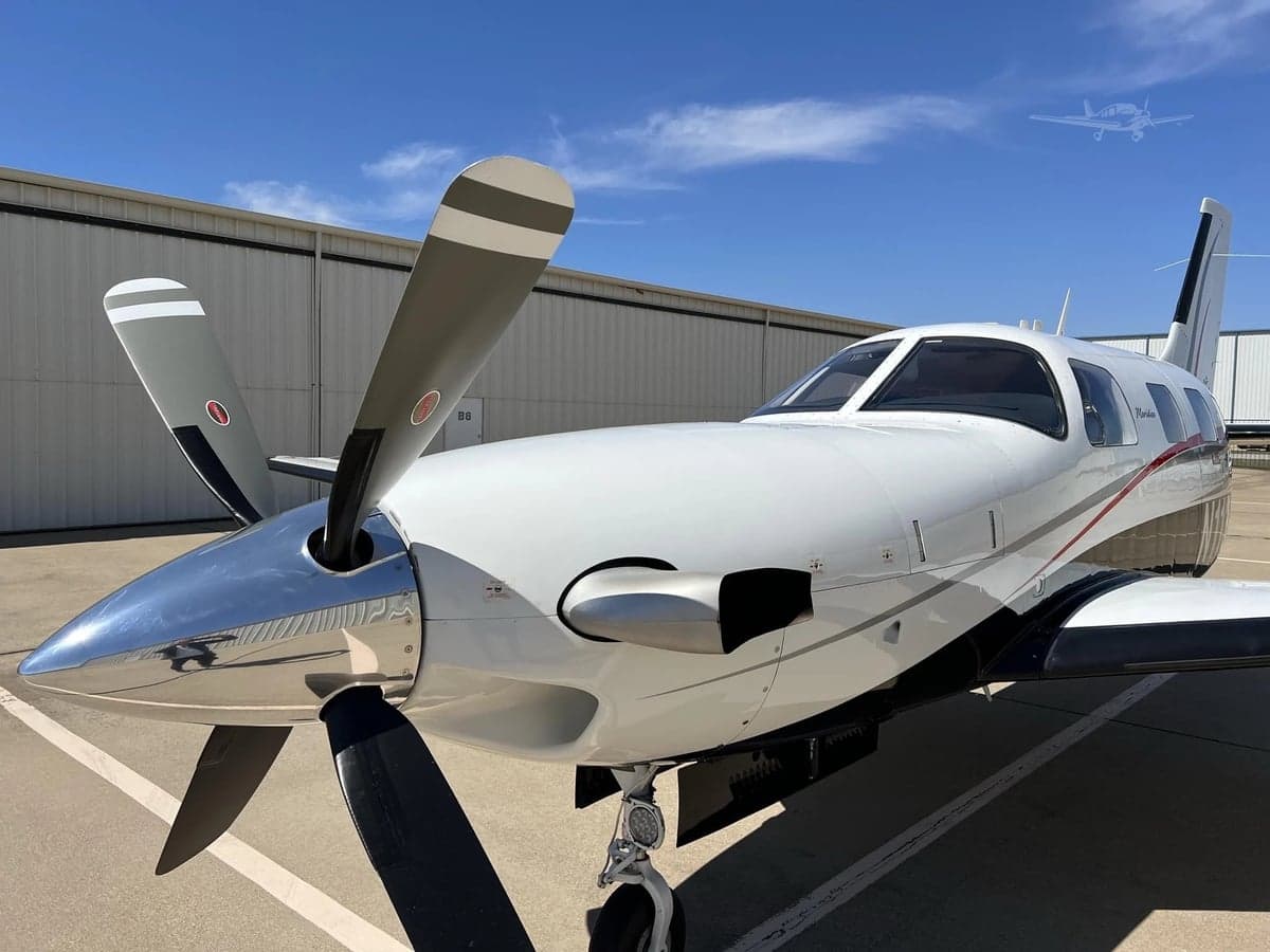 Close-up of the nose and propeller of a Piper Meridian aircraft.
