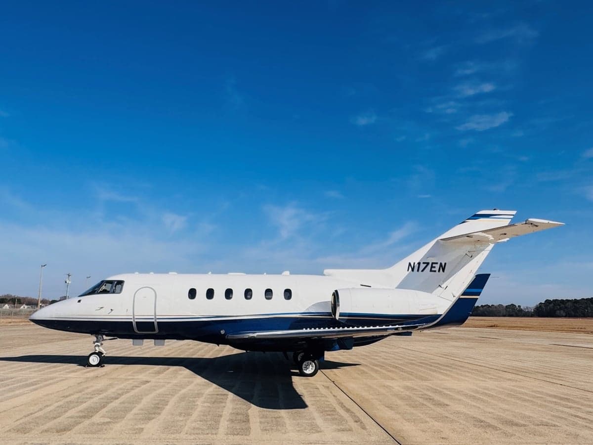 Side view of the aircraft N17EN on the tarmac with a blue and white paint scheme.
