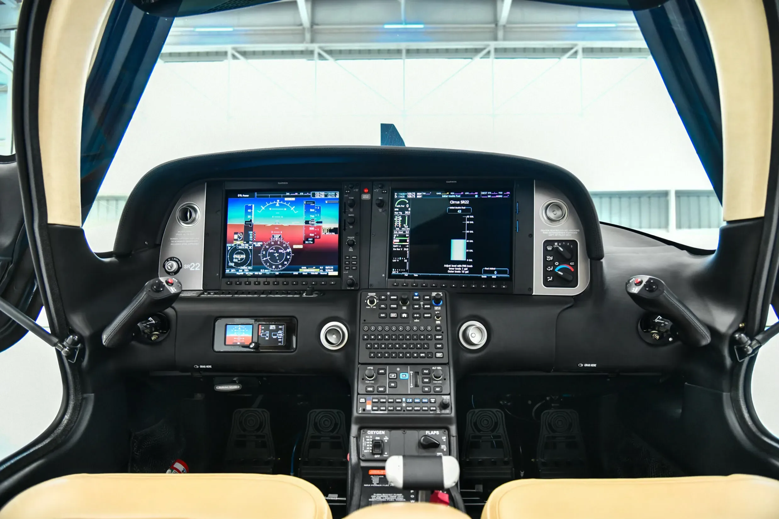 The modern glass cockpit of a Cirrus SR22 aircraft, featuring multiple digital displays and controls.