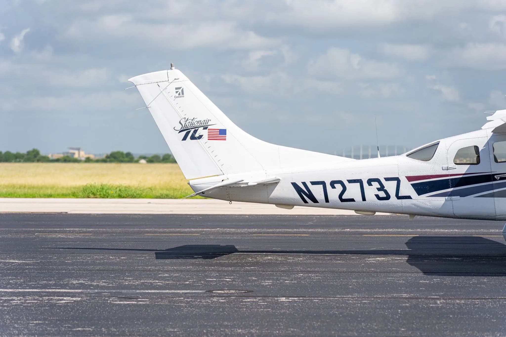 A close-up of the tail of a white Cessna Stationair TC, showing the N-number and "Stationair TC" logo.