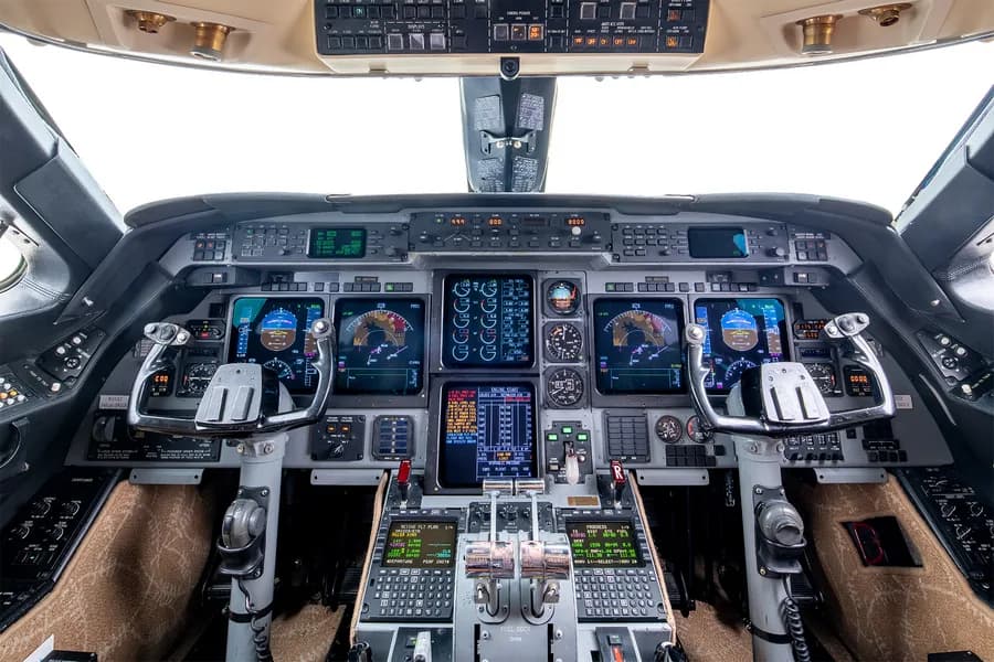 Aircraft cockpit with instrument panel and controls.