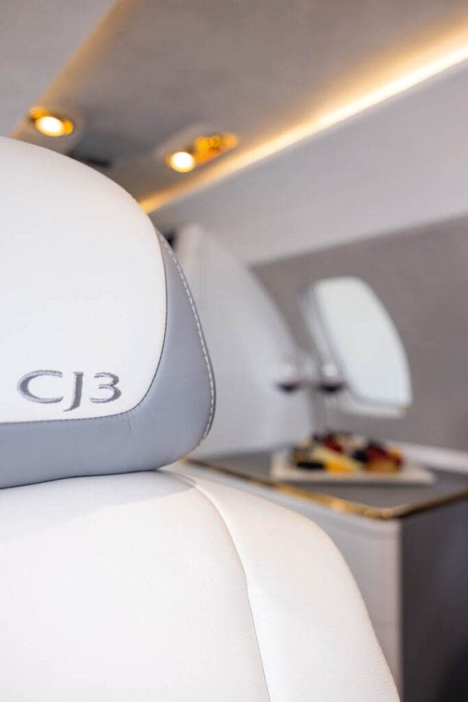 Close-up of a Citation CJ3 seat with the CJ3 logo embroidered on the headrest.