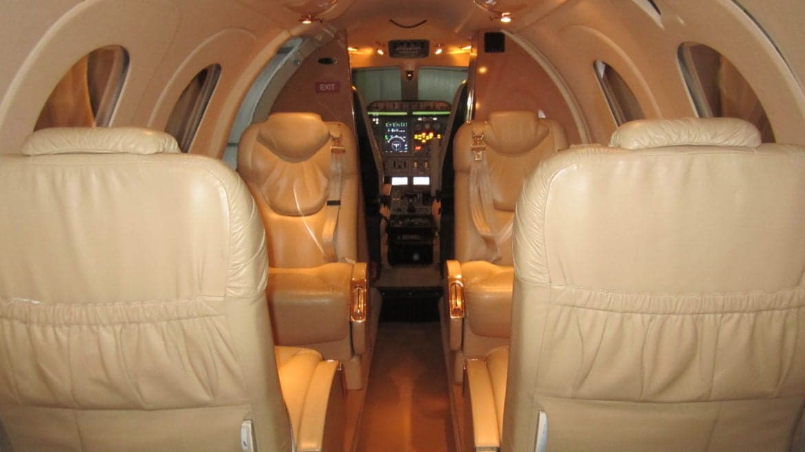 View of the aircraft cabin from the rear seats looking towards the cockpit.