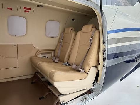 A Cirrus SR22T aircraft with registration N461J parked inside a hangar.