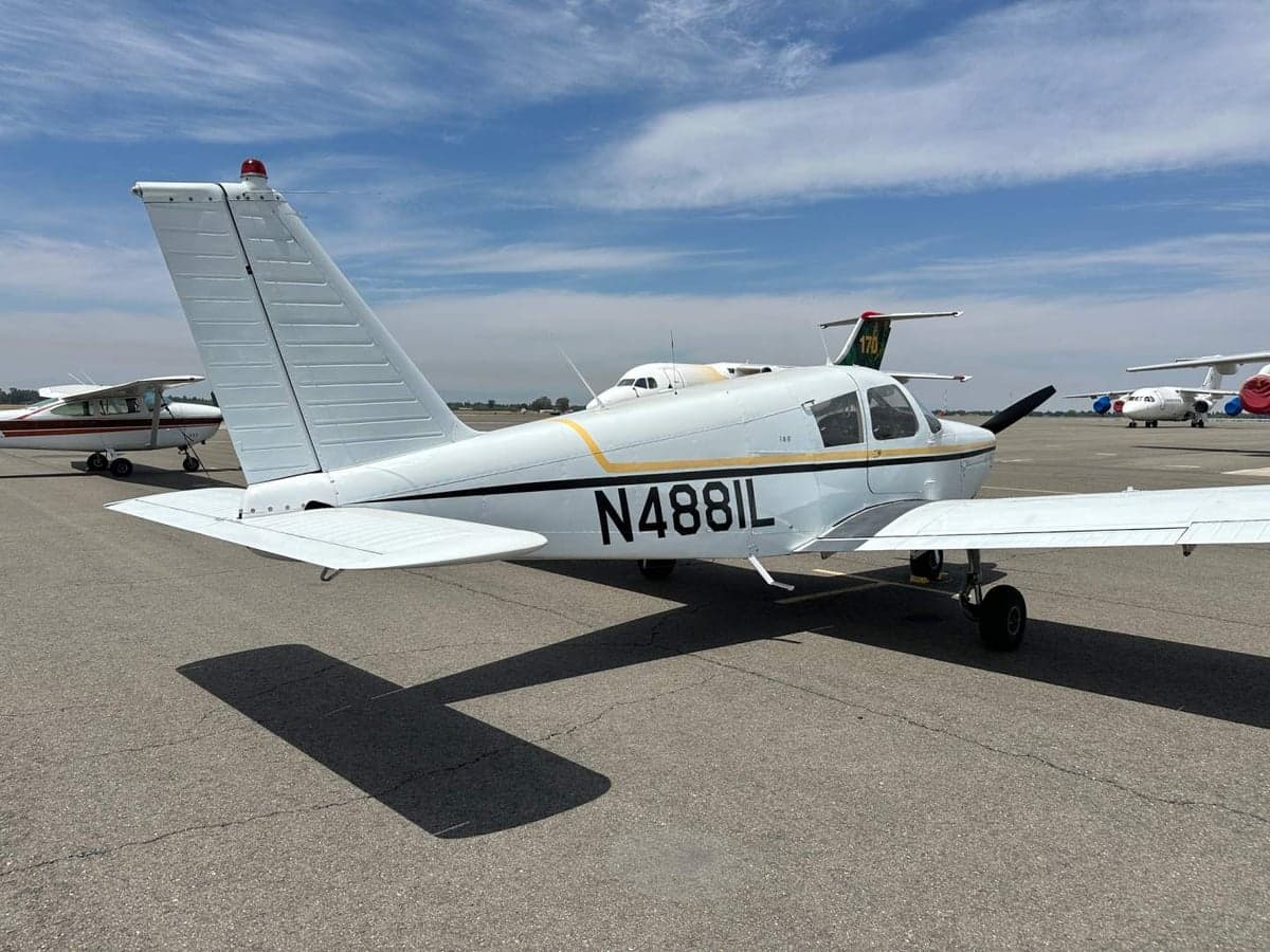A Piper PA-28-140 Cherokee with tail number N4881L parked on the tarmac.