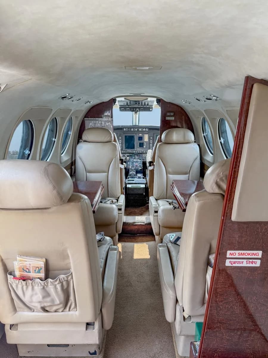 Cabin view of the King Air with leather seats and tables.