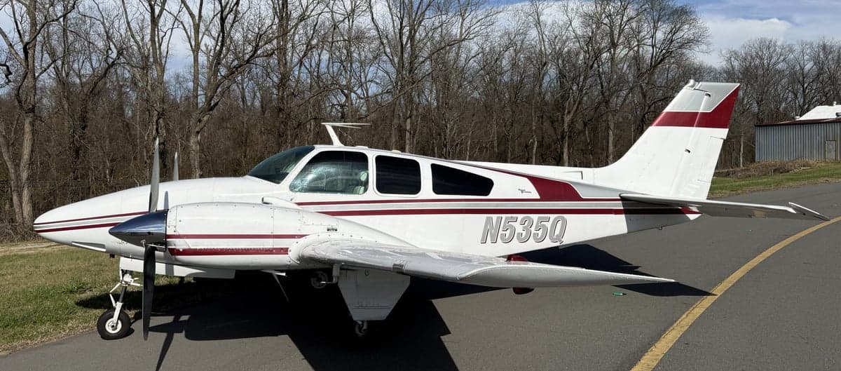 N535Q Beechcraft on the tarmac with a white and maroon paint scheme.