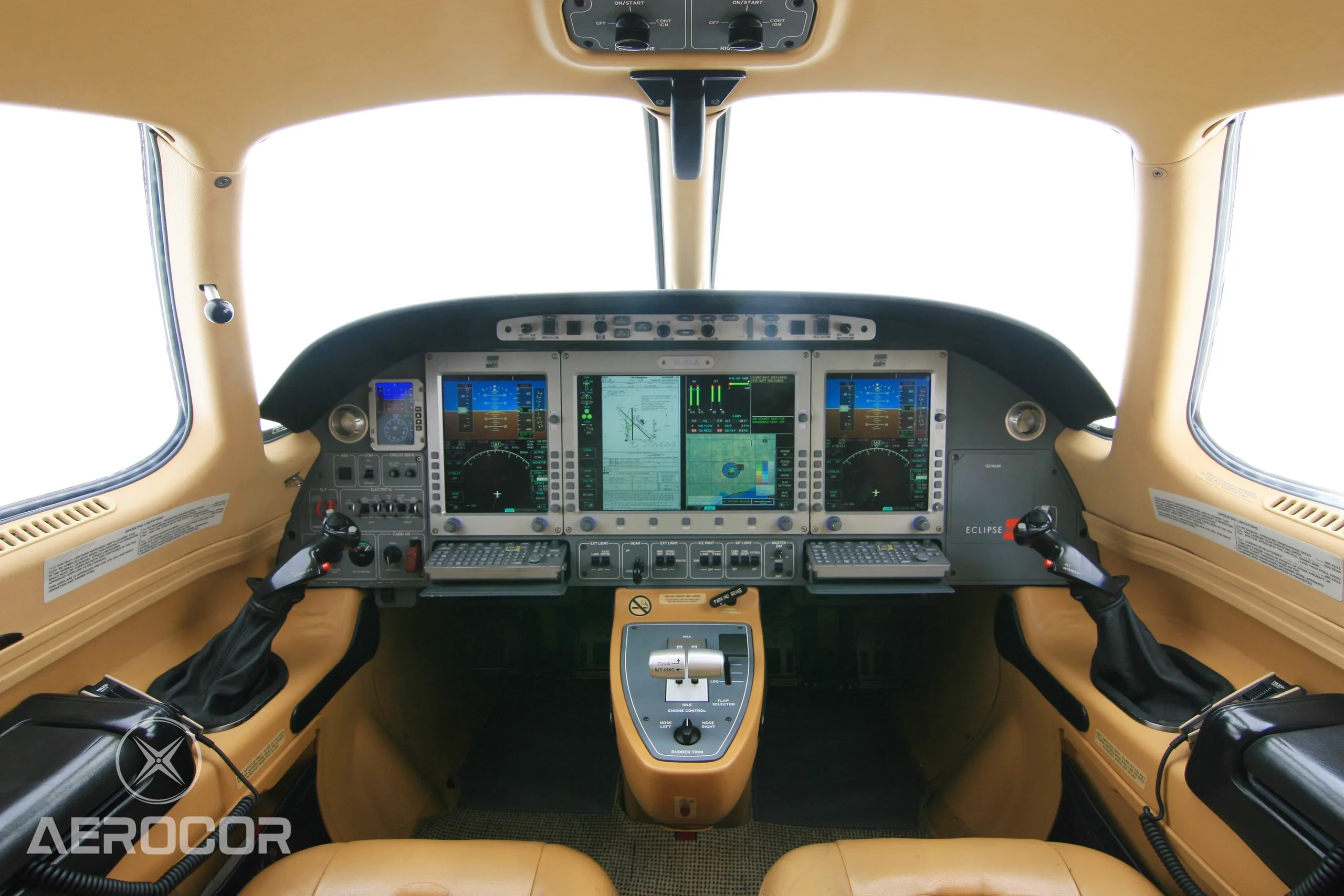The cockpit of an Eclipse 500 jet, showing the instrument panel with multiple screens and controls.