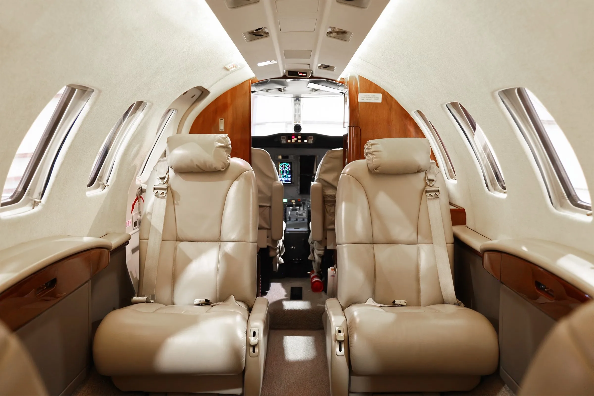 The beige leather cabin seats of the Cessna Citation CJ2+ interior, viewed from the rear looking towards the cockpit.