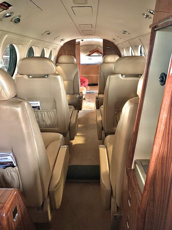 A view of the interior cabin of the aircraft, showing the seating arrangement.