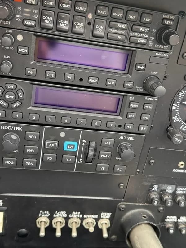 A close-up view of the avionics stack and control switches in an aircraft cockpit.