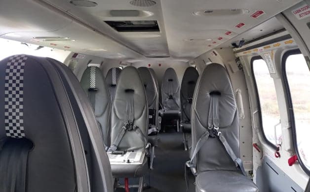 Helicopter cockpit instrument panel with multiple displays.