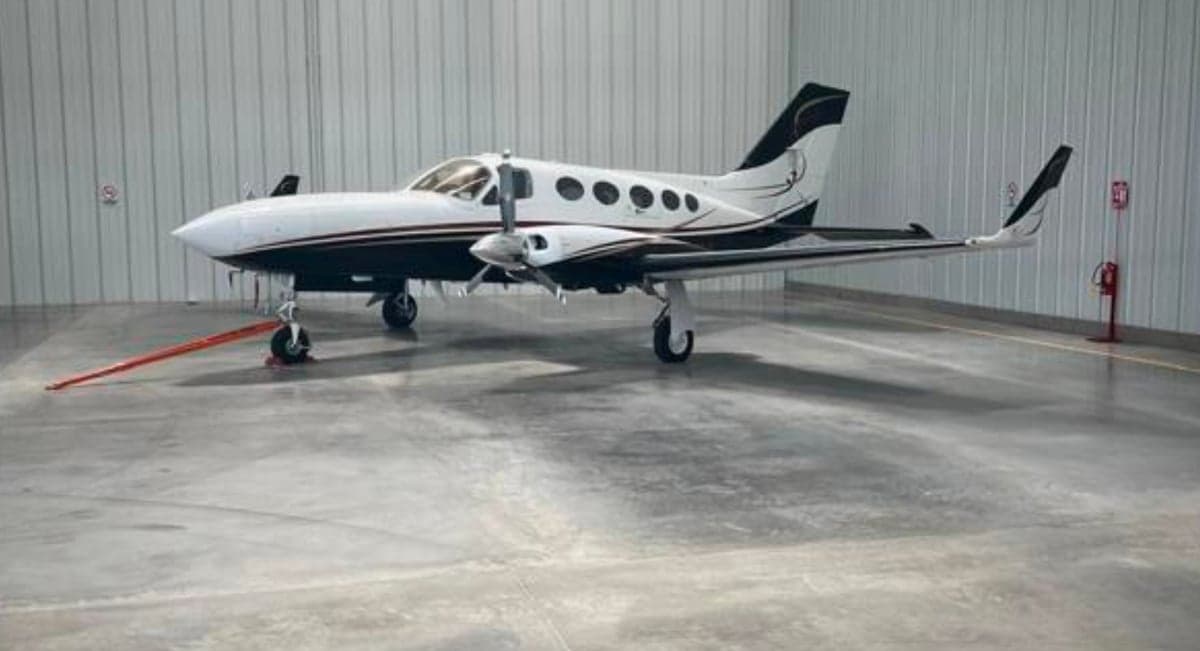 A Cessna 421 Golden Eagle aircraft is parked in a hangar.