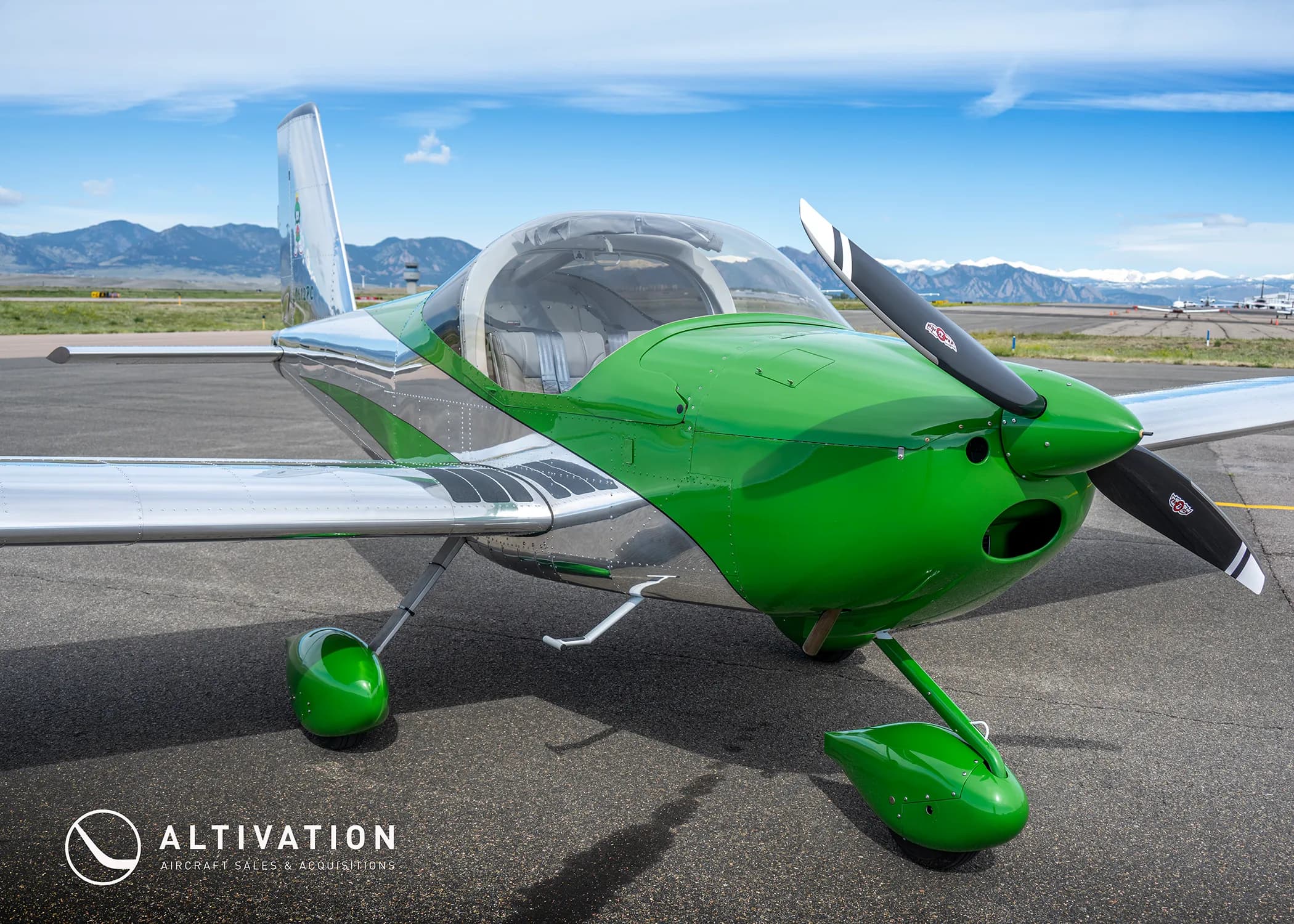 A front three-quarter view of a green and polished aluminum Vans RV-12 aircraft with registration N612PC on an airfield.