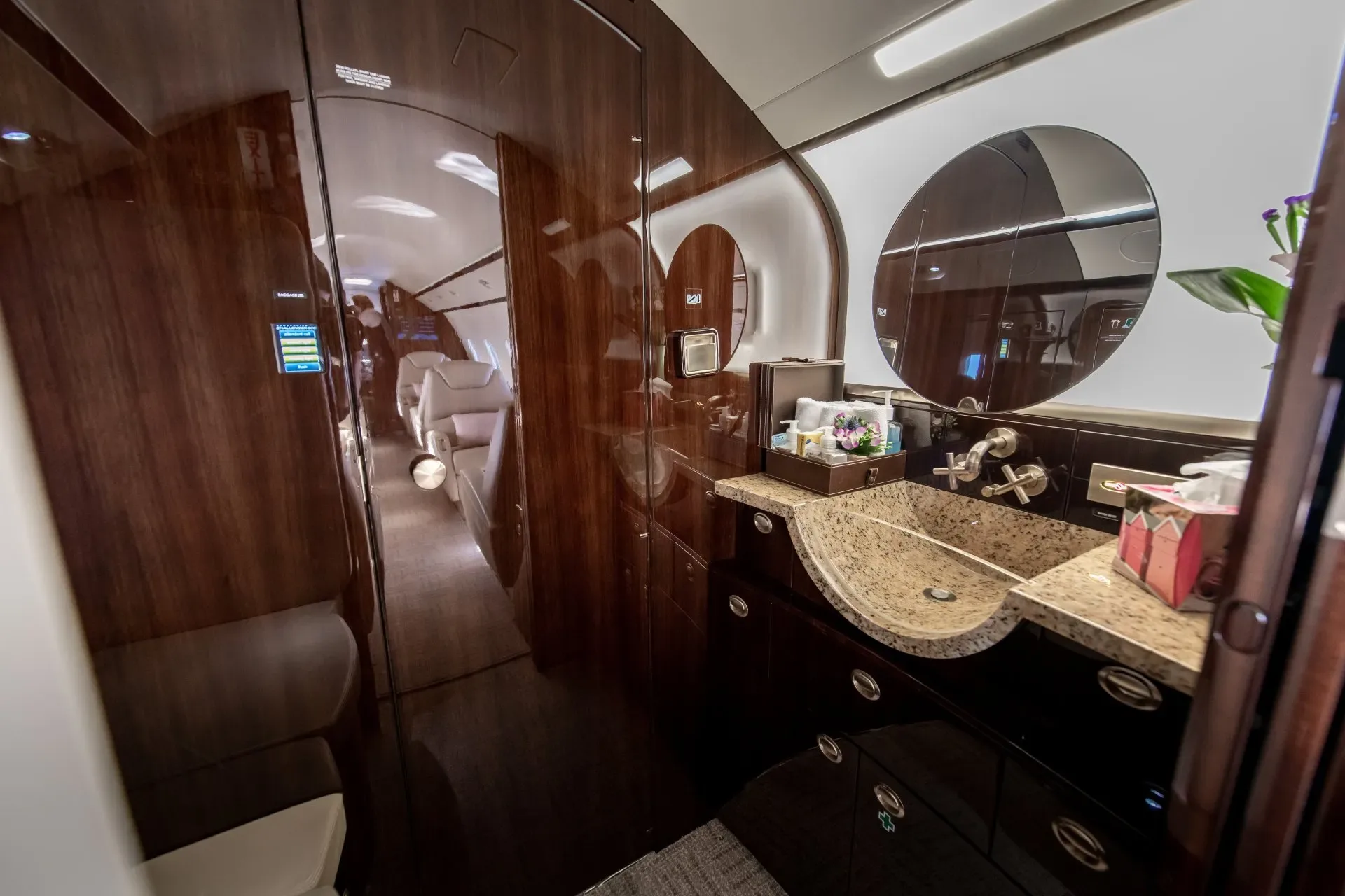 A view of the aircraft's lavatory with a sink and mirror.
