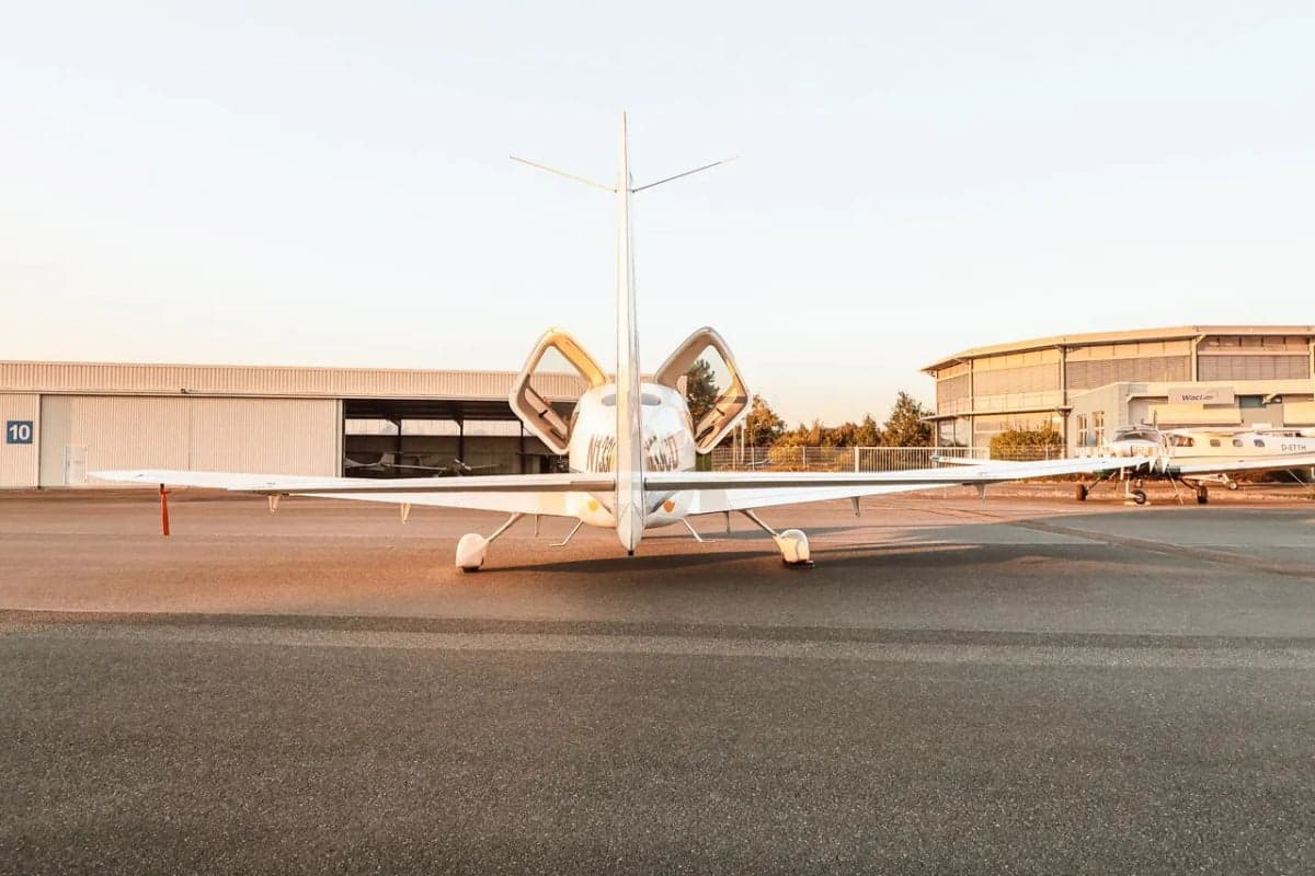 Rear view of Cirrus SR22 aircraft N133CD with doors open.