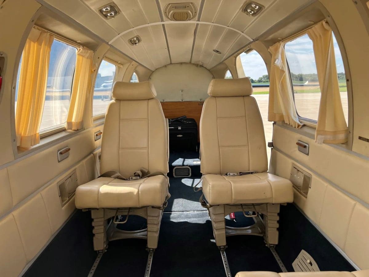 Interior view of the aircraft cabin showing the front seats and cockpit.