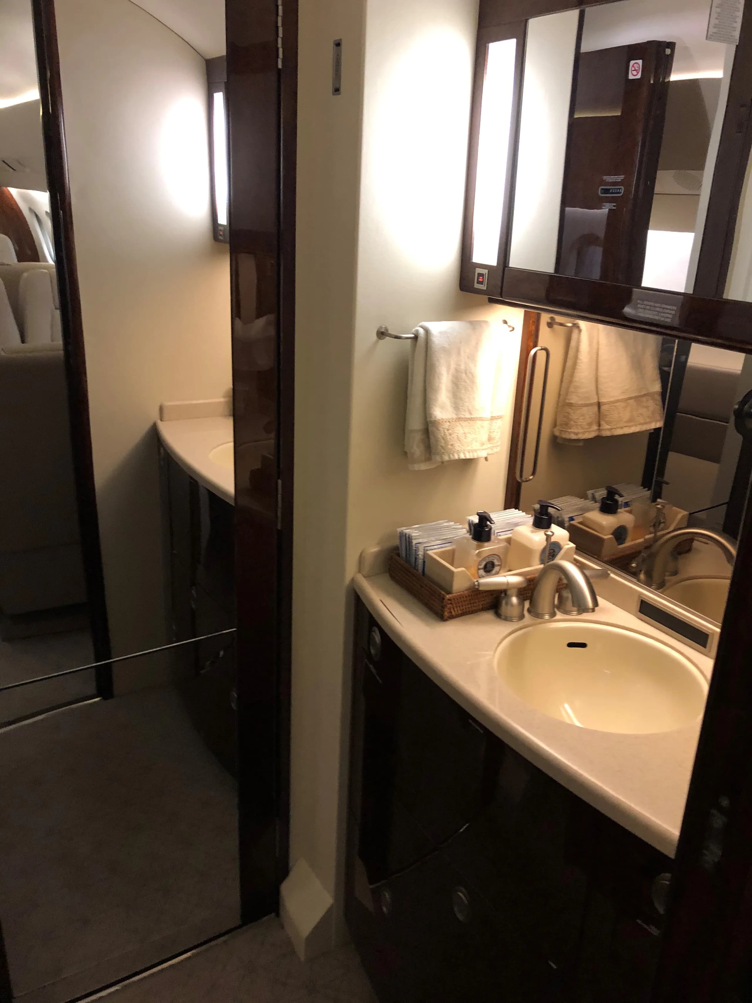 A view of the aircraft's lavatory, featuring a sink and mirror.
