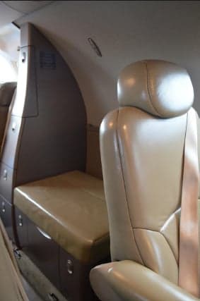 Interior of the Citation Mustang showing a side console and seating.