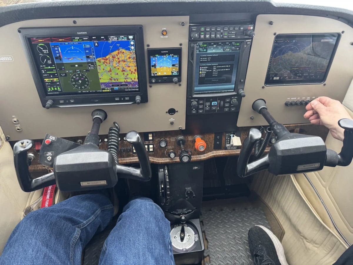 The cockpit of N4855G features a modern glass panel and beige interior.