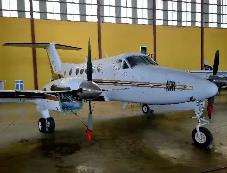 Front view of a King Air aircraft inside a hangar.