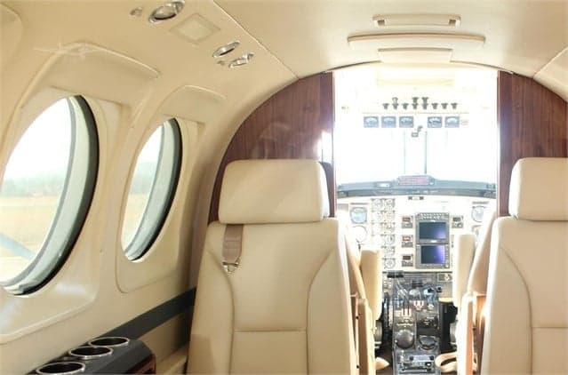 The interior of the King Air aircraft features leather seats and wood trim.