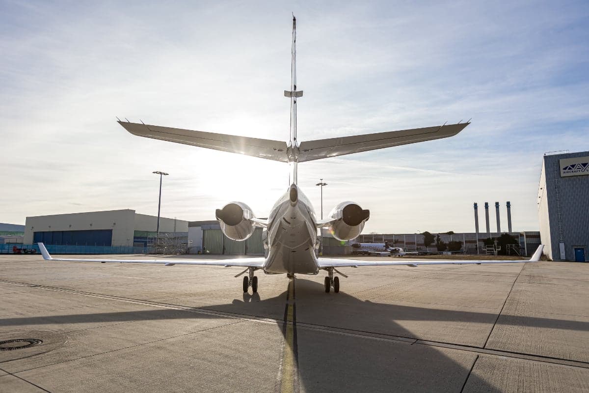 Rear view of a Gulfstream G200 aircraft with the tail number OK-GLX parked on the tarmac.