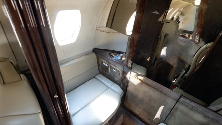 View of the side seating and cabinetry in the Cessna Citation CJ3 cabin.