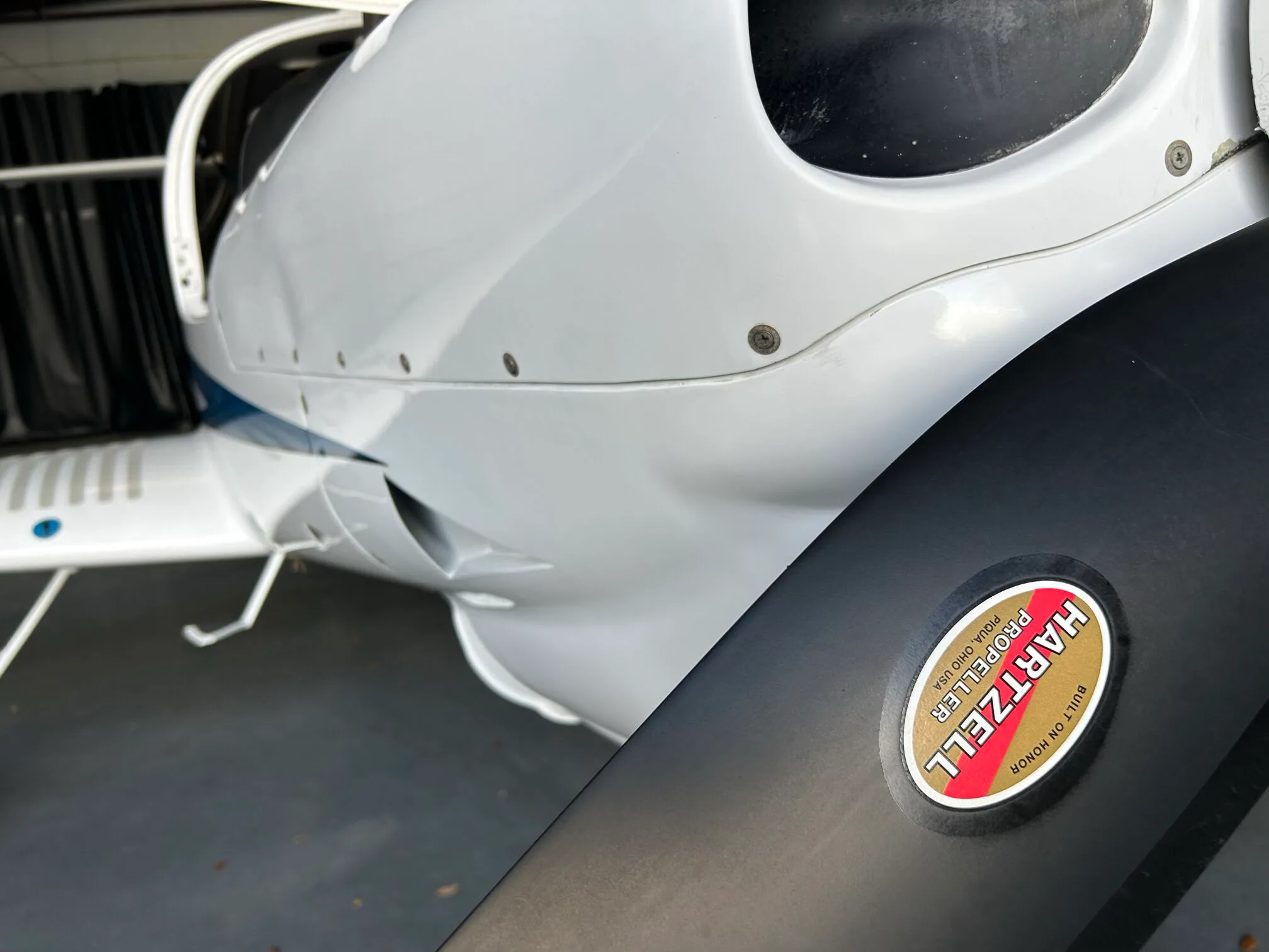 Close-up view of the Hartzell propeller blade on a white Diamond DA40 aircraft.