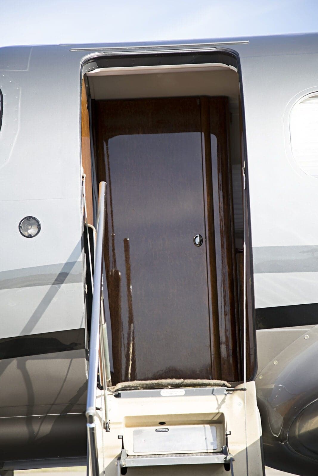 Close-up of the open door and steps of the Pilatus PC-12 aircraft.